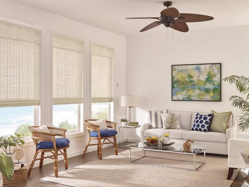 Natural woven shades covering bright living room windows.