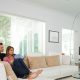 Motorized shades covering windows in a bright living room