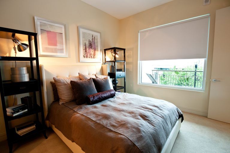 Solar roller shade filtering sunlight in a Johnson County bedroom